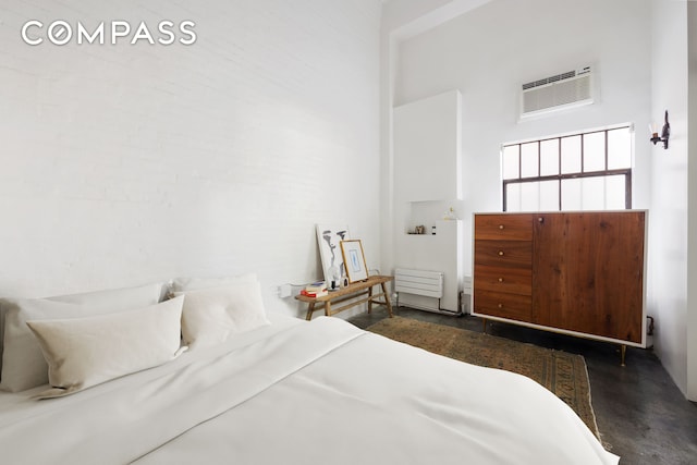 125 Watts St Unit 1, New York City, NY 10013 - bedroom with finished concrete flooring, a wall mounted air conditioner, and a high ceiling