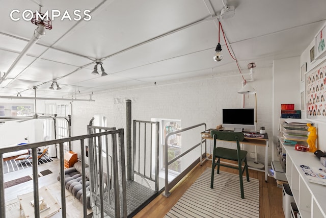 125 Watts St Unit 1, New York City, NY 10013 - home office with wood finished floors, healthy amount of natural light, and brick wall