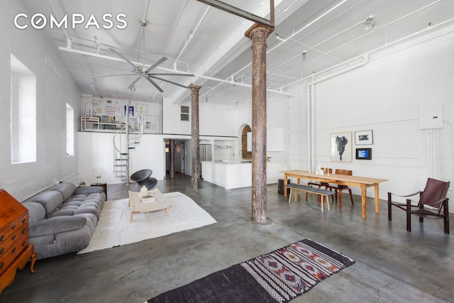 125 Watts St Unit 1, New York City, NY 10013 - living area with finished concrete flooring, ceiling fan, and ornate columns