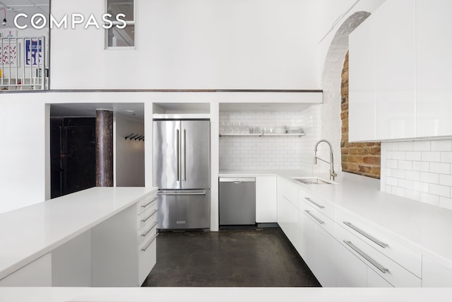 125 Watts St Unit 1, New York City, NY 10013 - kitchen featuring stainless steel appliances, open shelves, finished concrete flooring, white cabinets, and light countertops