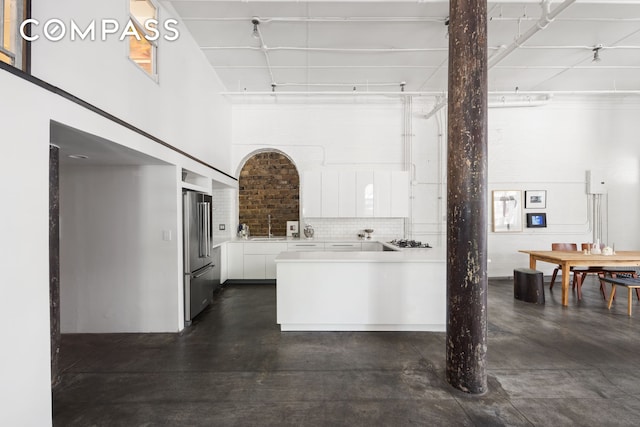 125 Watts St Unit 1, New York City, NY 10013 - kitchen with high end refrigerator, white cabinetry, light countertops, a peninsula, and modern cabinets