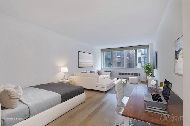 333 E 14th St Unit 5L, New York City, NY 10003 - bedroom featuring radiator, crown molding, and wood finished floors
