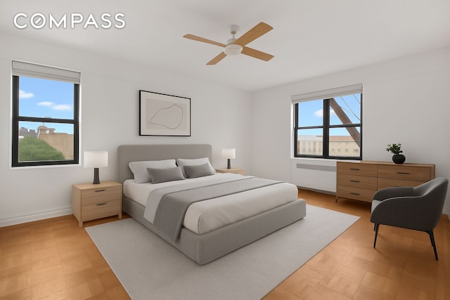 200 Pinehurst Ave Unit 5C, New York City, NY 10033 - bedroom featuring radiator, light flooring, and a ceiling fan