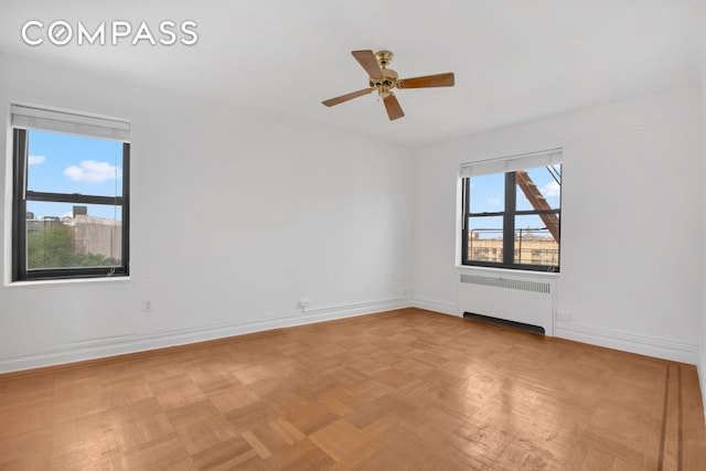 200 Pinehurst Ave Unit 5C, New York City, NY 10033 - spare room featuring radiator heating unit and ceiling fan