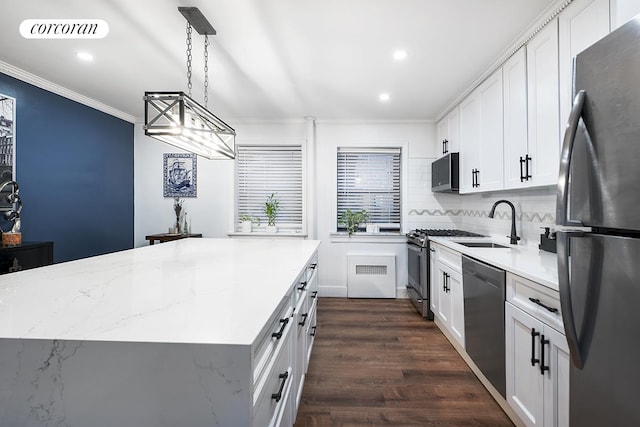 34-10 94th St Unit 1A, New York City, NY 11372 - kitchen with appliances with stainless steel finishes, ornamental molding, white cabinets, dark wood-style floors, and recessed lighting