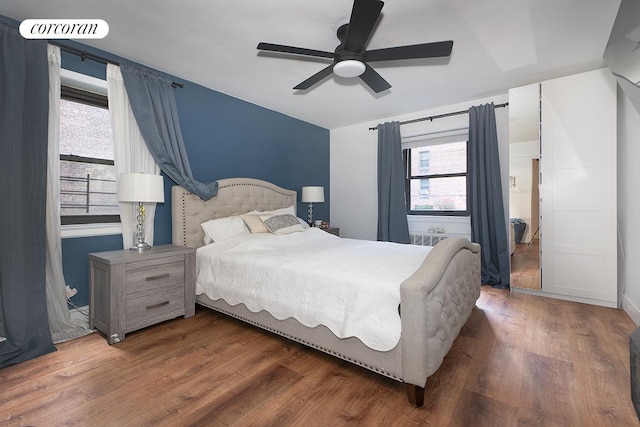 34-10 94th St Unit 1A, New York City, NY 11372 - bedroom featuring wood finished floors, multiple windows, and ceiling fan