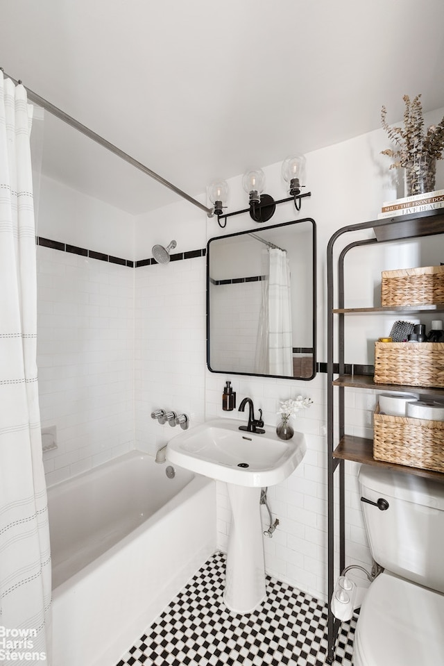 205 Clinton Ave Unit 11F, New York City, NY 11205 - bathroom featuring shower / bathtub combination with curtain and tile walls