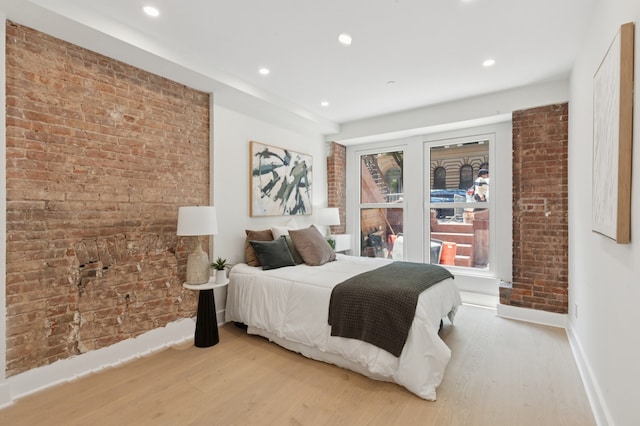 53 W 119th St Unit 1, New York City, NY 10026 - bedroom featuring light wood finished floors, brick wall, and recessed lighting