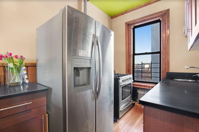 110 Cambridge Pl Unit 5-B, New York City, NY 11238 - kitchen featuring stainless steel appliances, light wood-style flooring, and dark countertops