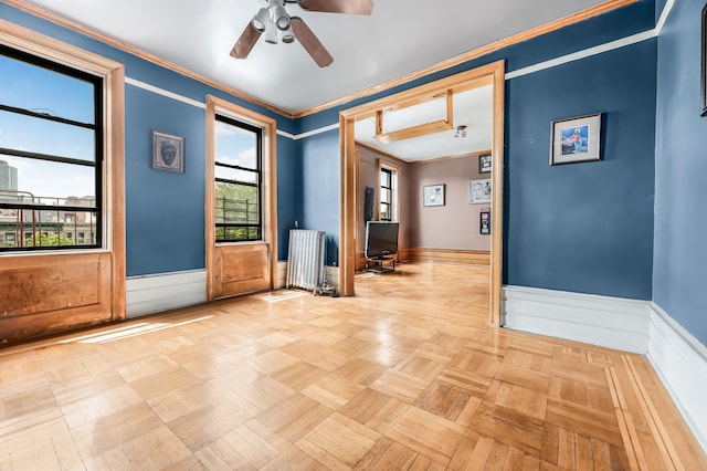 110 Cambridge Pl Unit 5-B, New York City, NY 11238 - unfurnished room featuring a wainscoted wall, ceiling fan, a desk, and ornamental molding