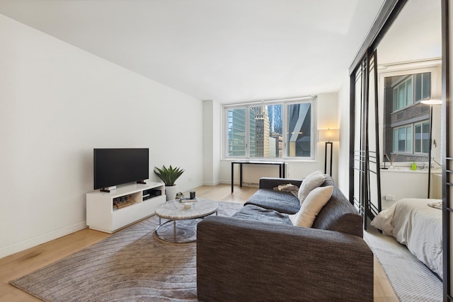 322 W 57th St Unit 18J, New York City, NY 10019 - living room with wood finished floors and baseboards