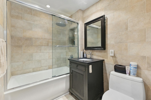 322 W 57th St Unit 18J, New York City, NY 10019 - bathroom featuring tile walls, vanity, and enclosed tub / shower combo