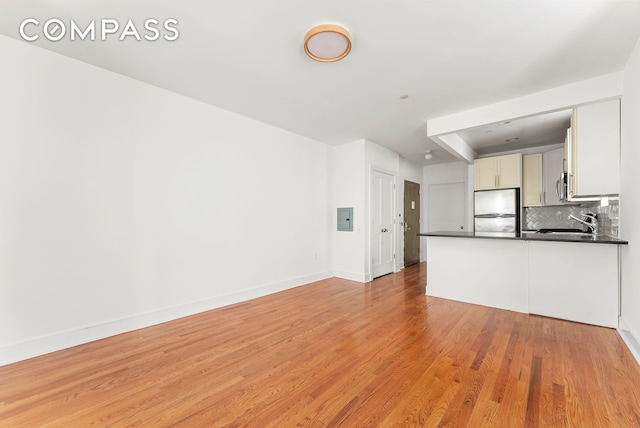 305 W 150th St Unit 511, New York City, NY 10039 - unfurnished living room featuring light wood-style flooring and electric panel