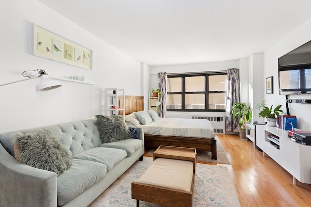 240 E 76th St Unit 3W, New York City, NY 10021 - bedroom with radiator and light wood finished floors