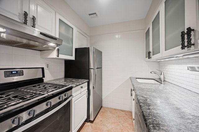 250 W 15th St Unit 6F, New York City, NY 10011 - kitchen with stainless steel appliances, dark stone counters, extractor fan, white cabinetry, and decorative backsplash