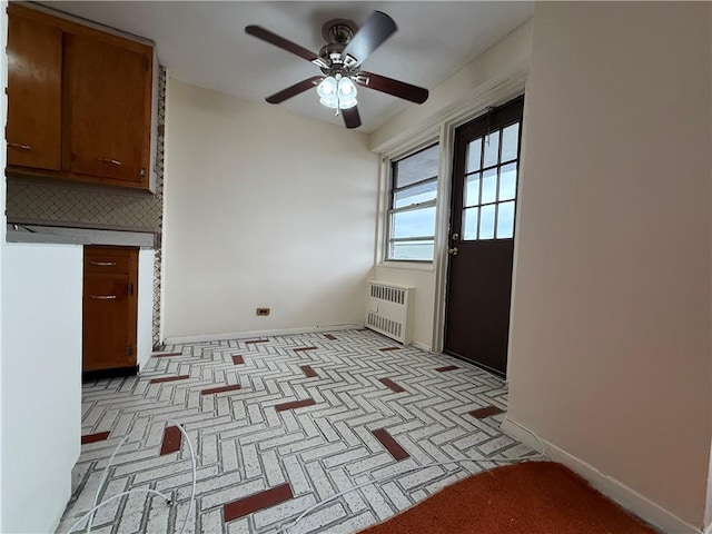 2475 W 16th St Unit 18-G, New York City, NY 11214 - kitchen with radiator, a ceiling fan, tasteful backsplash, and brown cabinetry