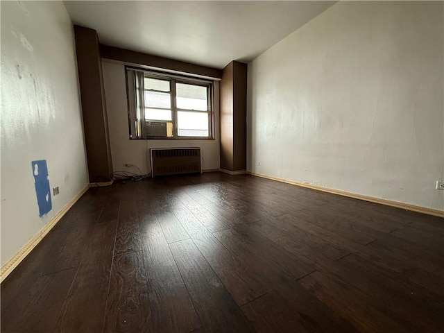 2475 W 16th St Unit 18-G, New York City, NY 11214 - spare room with radiator heating unit, wood-type flooring, and cooling unit