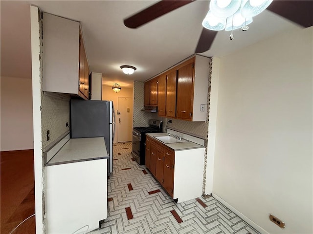 2475 W 16th St Unit 18-G, New York City, NY 11214 - kitchen featuring gas range, ceiling fan, decorative backsplash, freestanding refrigerator, and under cabinet range hood