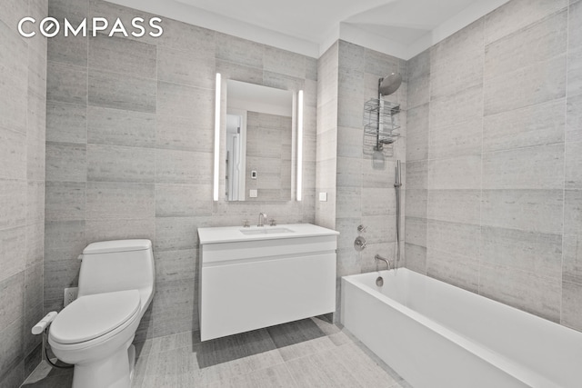 8 S 4th St Unit 15D, New York City, NY 11249 - bathroom with tile walls, vanity, bathtub / shower combination, and tile patterned floors