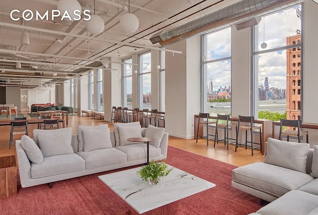 8 S 4th St Unit 15D, New York City, NY 11249 - living room featuring wood finished floors, healthy amount of natural light, and a city view