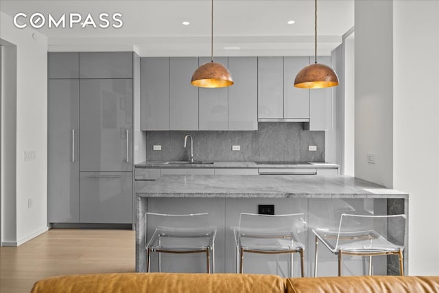 8 S 4th St Unit 15D, New York City, NY 11249 - kitchen featuring gray cabinets, modern cabinets, a kitchen breakfast bar, and recessed lighting
