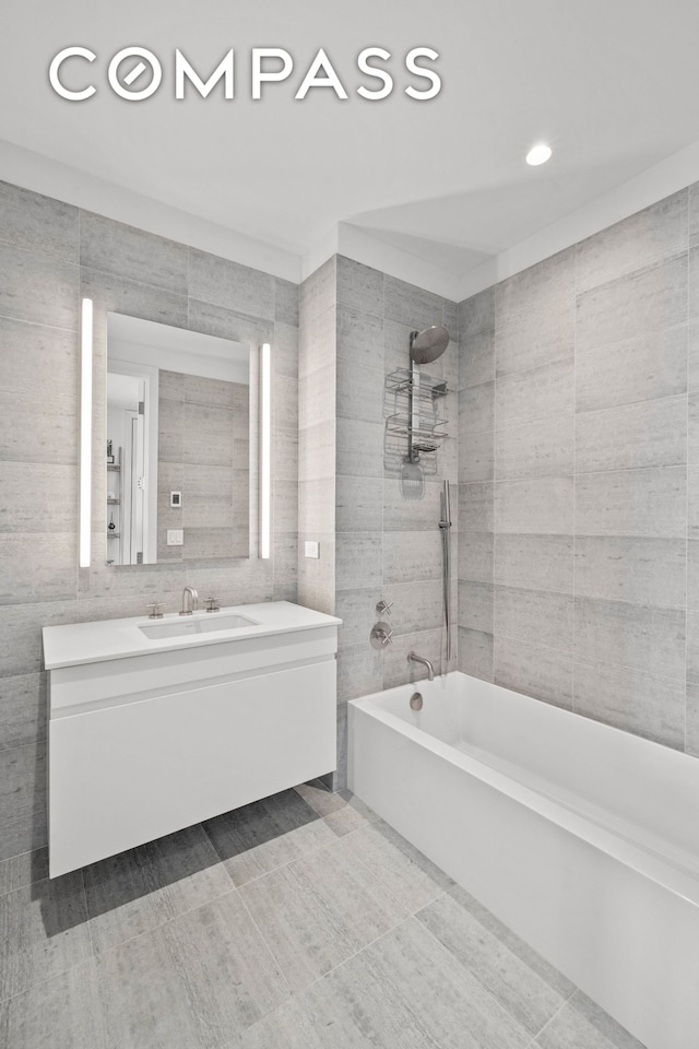 8 S 4th St Unit 15D, New York City, NY 11249 - bathroom featuring tile walls, vanity, bathtub / shower combination, and recessed lighting