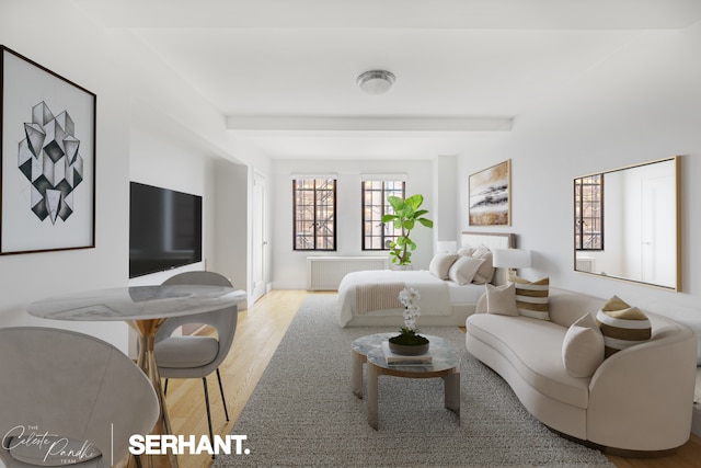 320 E 42nd St Unit 705, New York City, NY 10017 - bedroom featuring radiator, wood finished floors, and beamed ceiling