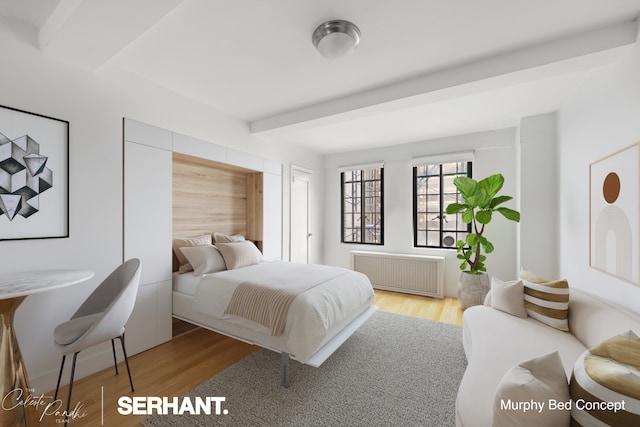 320 E 42nd St Unit 705, New York City, NY 10017 - bedroom with radiator, wood finished floors, and beamed ceiling