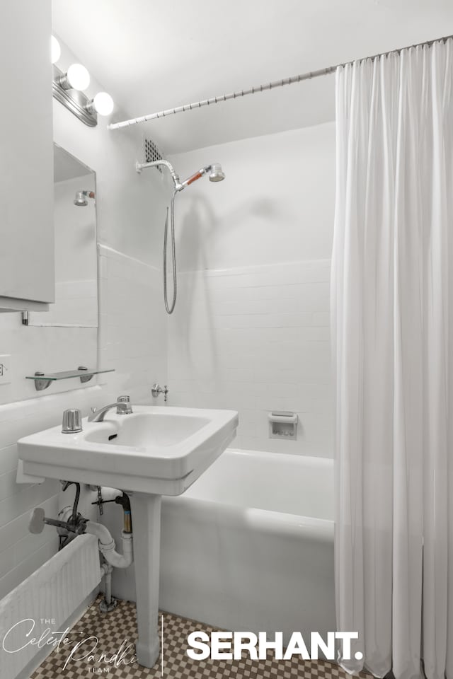 320 E 42nd St Unit 705, New York City, NY 10017 - bathroom featuring shower / bathtub combination with curtain