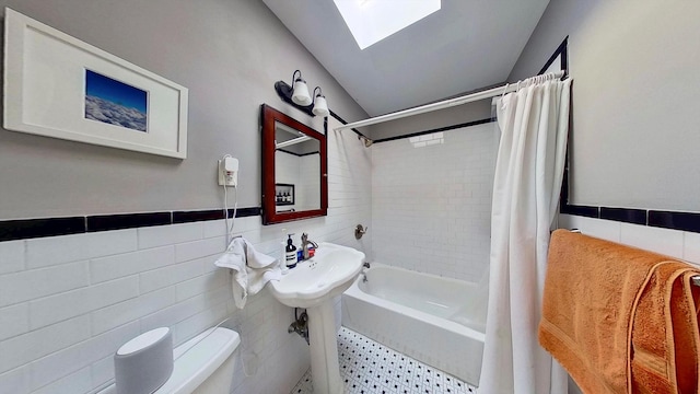 125 Washington Ave, New York City, NY 11205 - bathroom with tile walls, shower / bath combo, a skylight, and lofted ceiling