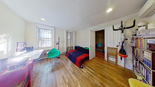 125 Washington Ave, New York City, NY 11205 - bedroom featuring a wall mounted air conditioner, wood finished floors, baseboard heating, and recessed lighting