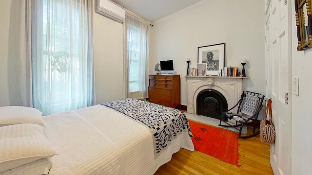 125 Washington Ave, New York City, NY 11205 - bedroom featuring a wall mounted AC, crown molding, wood finished floors, and a fireplace with flush hearth