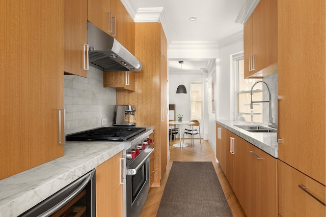 140 W 10th St Unit 3R, New York City, NY 10014 - kitchen with under cabinet range hood, high end range, ornamental molding, brown cabinetry, and tasteful backsplash