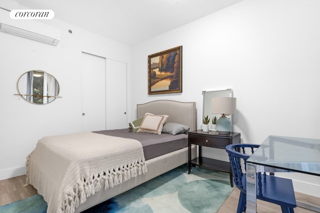 631 E 18th St Unit 2B, New York City, NY 11226 - bedroom with light wood-type flooring, a closet, and an AC wall unit
