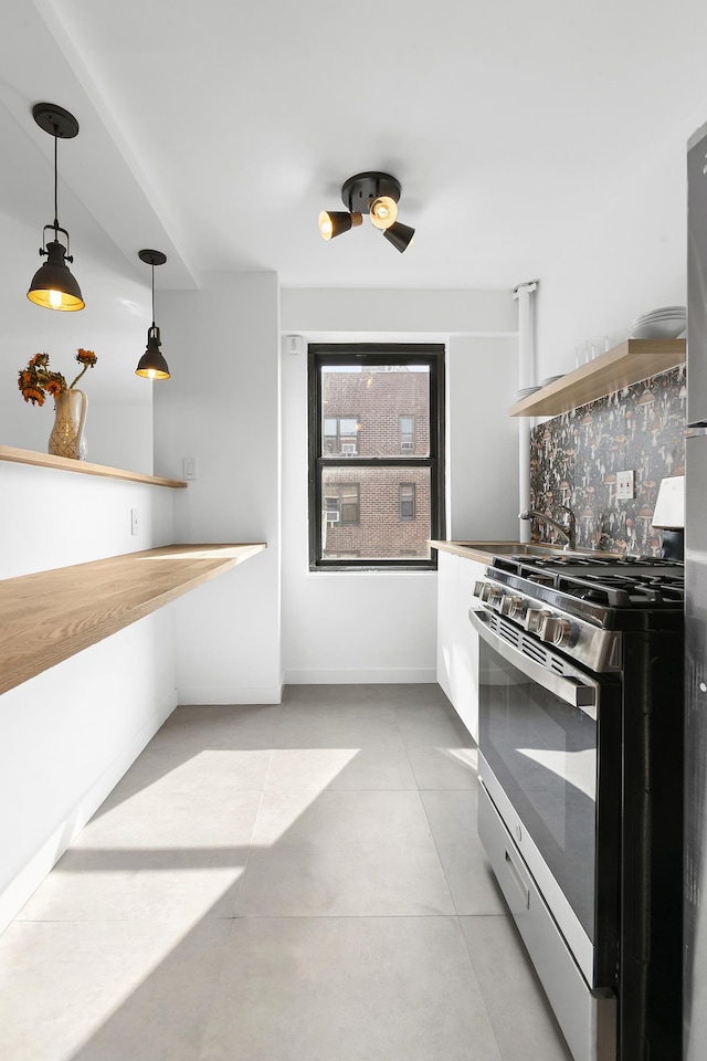 266 E Broadway Unit B-1902, New York City, NY 10002 - kitchen featuring stainless steel gas range oven, pendant lighting, light tile patterned floors, and open shelves