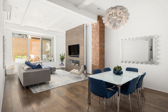 21 E 22nd St Unit 2B, New York City, NY 10010 - dining room with hardwood / wood-style floors, a chandelier, beam ceiling, and a fireplace