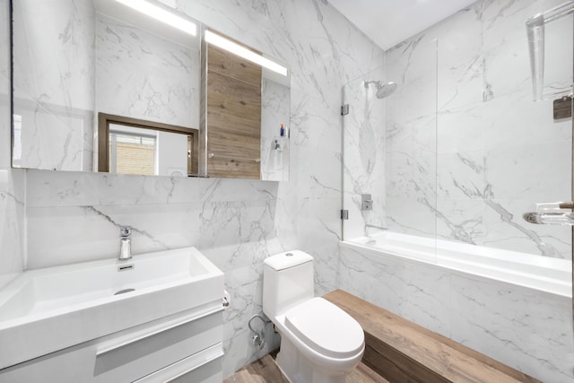21 E 22nd St Unit 2B, New York City, NY 10010 - bathroom featuring tile walls, vanity, and a combined bath / shower with marble appearance