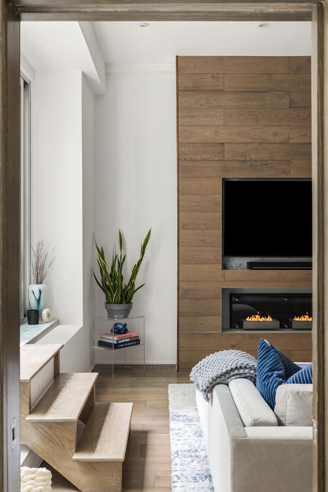 21 E 22nd St Unit 2B, New York City, NY 10010 - living area featuring wood finished floors and a warm lit fireplace