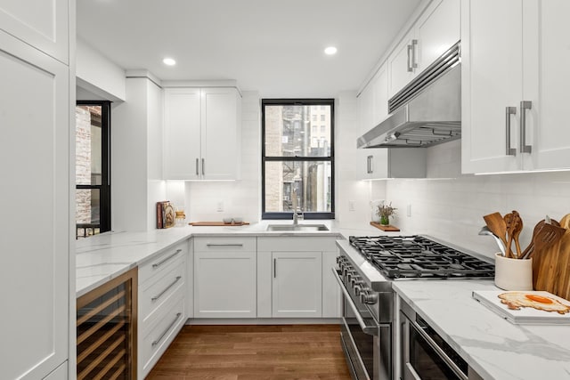 255 W 98th St Unit 5A, New York City, NY 10025 - kitchen featuring under cabinet range hood, beverage cooler, high end stainless steel range, healthy amount of natural light, and recessed lighting