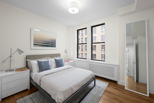 255 W 98th St Unit 5A, New York City, NY 10025 - bedroom featuring wood finished floors and radiator heating unit