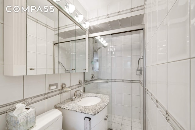 400 E 85th St Unit 15F, New York City, NY 10028 - full bathroom with tile walls, a shower stall, and vanity