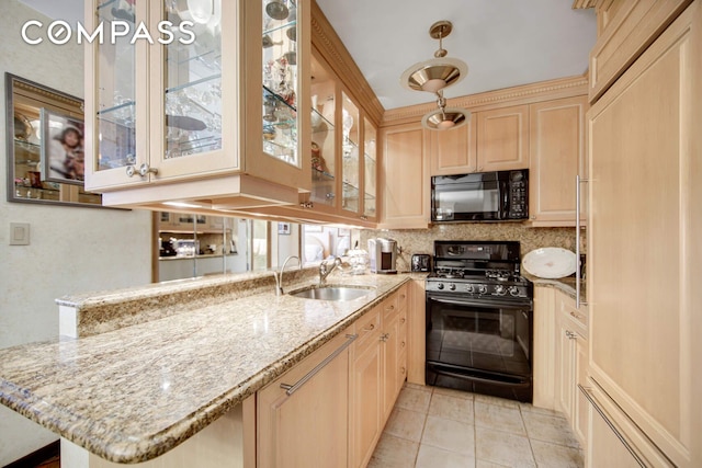 400 E 85th St Unit 15F, New York City, NY 10028 - kitchen with black appliances, light brown cabinetry, tasteful backsplash, light stone counters, and light tile patterned floors