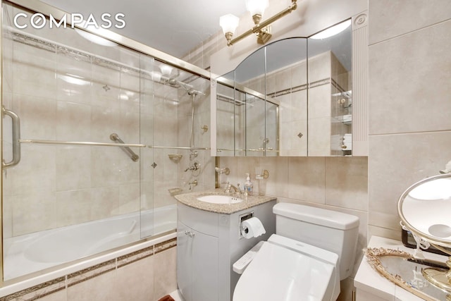 400 E 85th St Unit 15F, New York City, NY 10028 - full bathroom featuring vanity, tiled shower / bath, and tile walls