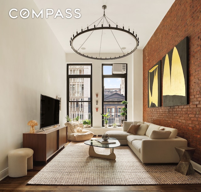 250 Mercer St Unit C302, New York City, NY 10012 - living room with wood finished floors, a towering ceiling, and brick wall