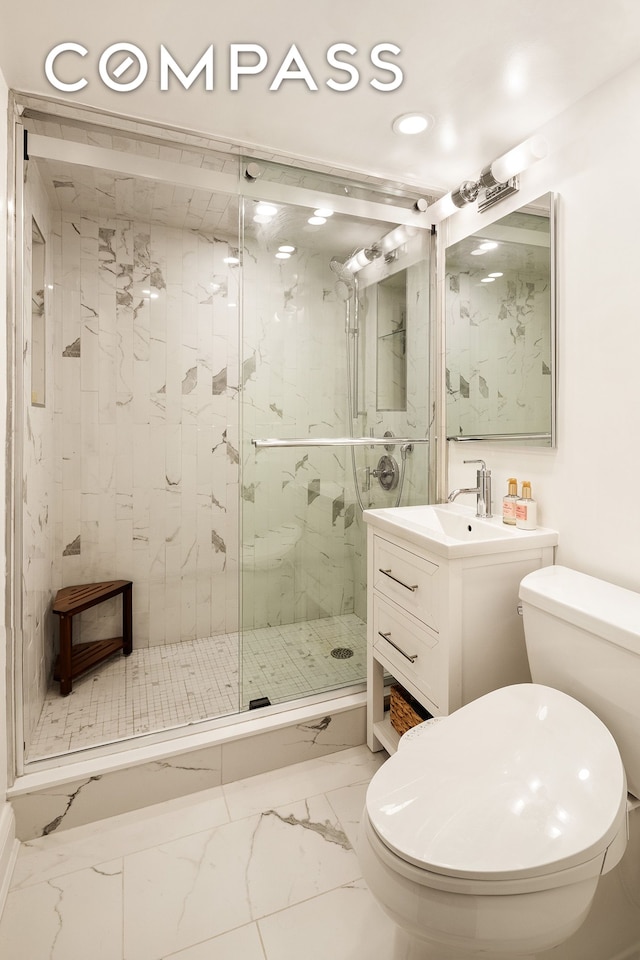 250 Mercer St Unit C302, New York City, NY 10012 - bathroom with marble look tile flooring, a marble finish shower, vanity, and recessed lighting