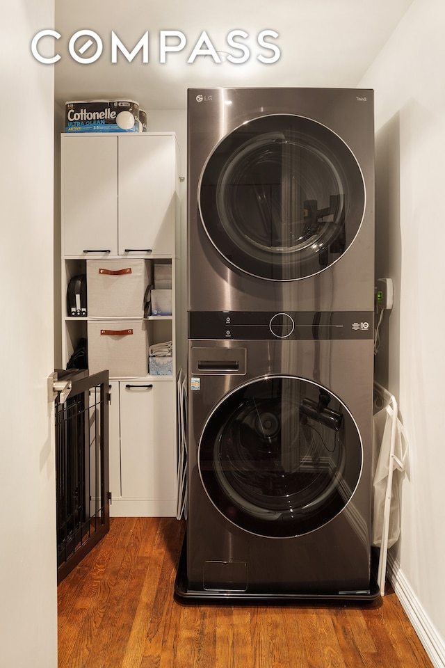 250 Mercer St Unit C302, New York City, NY 10012 - laundry room with stacked washer / dryer, wood finished floors, and cabinet space