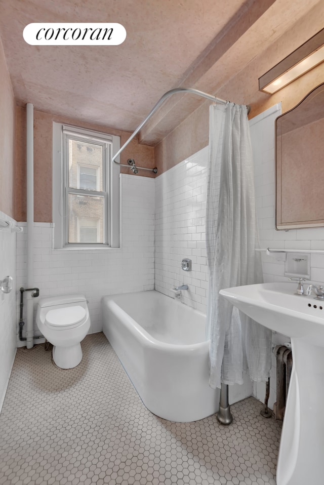 390 Riverside Dr Unit 11E, New York City, NY 10025 - bathroom featuring shower / bath combo, tile walls, and a wainscoted wall