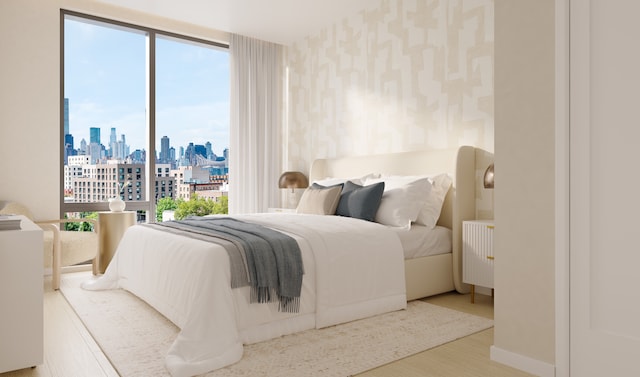11-36 45th Rd Unit 404A, New York City, NY 11101 - bedroom featuring a skyline view, wallpapered walls, wood finished floors, and radiator heating unit