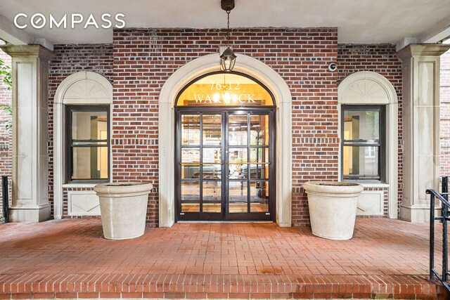 76-12 35th Ave Unit 6J, New York City, NY 11372 - doorway to property featuring brick siding