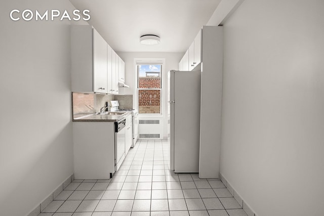 76-12 35th Ave Unit 6J, New York City, NY 11372 - kitchen with freestanding refrigerator, radiator, white cabinets, tasteful backsplash, and dishwashing machine